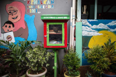 A colorfully painted book-sharing box offers free reading material along an alley in Jatipulo subdistrict, West Jakarta. JP/Afriadi Hikmal