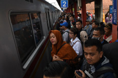Residents wait for a train at Bojong Gede Station, Cibinong, West Java, on Feb. 25, 2019. 