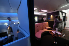 A picture taken on May 4, 2014 in Abu Dhabi shows the Lobby (R) of the new A380 aircraft of the United Arab Emirates airline carrier Etihad Airlines. 