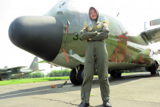 Sky rider: Anisa Amalia Octavia poses in front of a Hercules aircraft. 