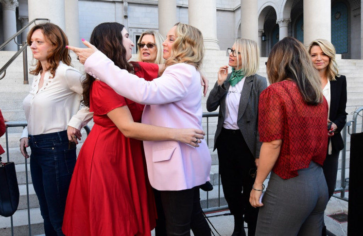 Lead plaintiff in the class action suit Louisette Geiss embraces Sarah Ann Masse (L) as a group of Hollywood actresses and others, part of a group of Silence Breakers who have fought for justice by speaking out about Harvey Weinstein’s sexual misconduct, gather during a press conference following Harvey Weinstein’s guilty verdict on February 25, 2020 in Los Angeles,California. - Harvey Weinstein was convicted February 24, 2020 of rape and sexual assault but acquitted of the most serious predatory charges, a verdict hailed as a historic victory by the #MeToo movement against sexual misconduct. 