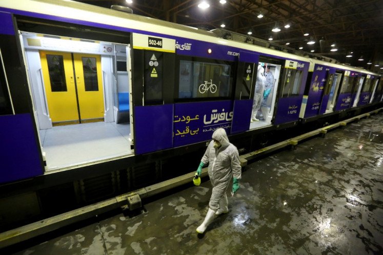 A Tehran Municipality worker cleans a metro train to avoid the spread of the COVID-19 illness on February 26, 2020. - Iran said Tuesday its coronavirus outbreak, the deadliest outside China, had claimed 15 lives and infected nearly 100 others -- including the country's deputy health minister. The Islamic republic's neighbours have imposed travel restrictions and strict quarantine measures after reporting their first cases in recent days, mostly in people with links to Iran. 