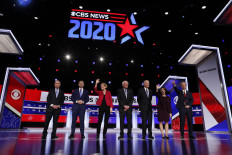 Obama absent from Democratic White House race but looming large