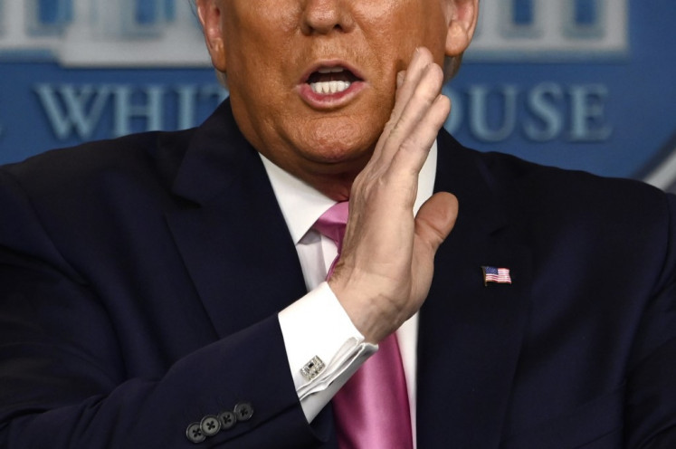 US President Donald Trump gestures as he speaks during a news conference on the COVID-19 outbreak at the White House on February 26, 2020. US President Donald Trump on Wednesday defended his administration's response to the novel coronavirus, lashing the media for spreading panic as he conducts an evening news conference on the epidemic.