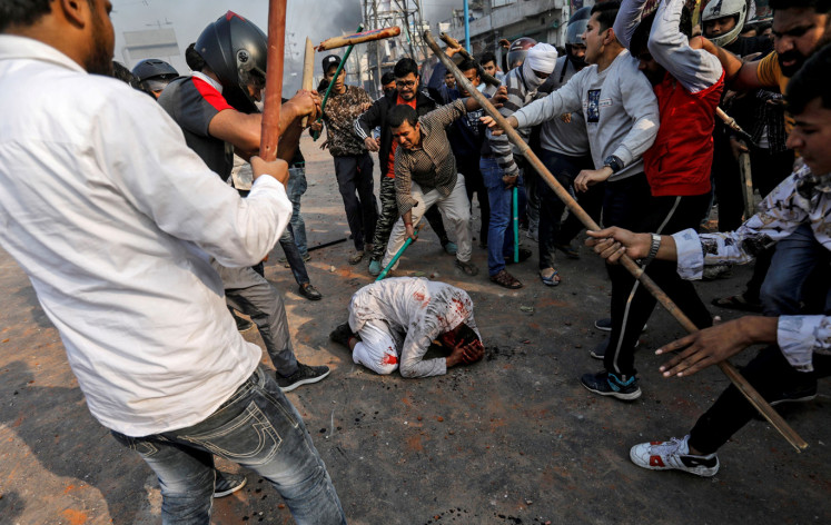  A group of men chanting pro-Hindu slogans, beat Mohammad Zubair, 37, who is Muslim, during protests sparked by a new citizenship law in New Delhi, India, February 24, 2020. 