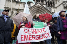Campaigners against the expansion of Heathrow Airport gather with placards and banners outside the Royal Courts of Justice in London on February 27, 2020 ahead of the decision on several judicial reviews on the UK government's approval of plans to expand capacity at the airport. 
