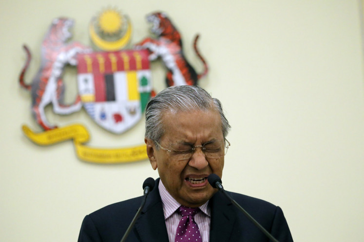 Malaysia's Interim Prime Minister Mahathir Mohamad reacts during a news conference in Putrajaya, Malaysia, February 27, 2020. 