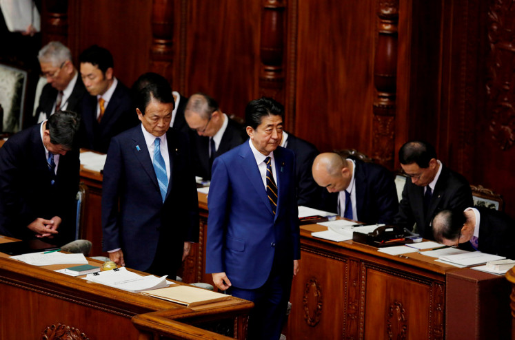 FILE PHOTO: Japanese Prime Minister Shinzo Abe and Finance Minister Taro Aso attend the regular session of parliament in Tokyo, Japan, January 20, 2020. 