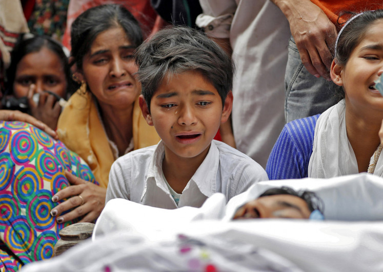 People mourn next to the body of Muddasir Khan, who was wounded on Tuesday in a clash between people demonstrating for and against a new citizenship law, after he succumbed to his injuries, in a riot affected area in New Delhi, India, February 27, 2020.