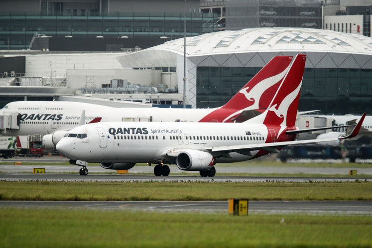 A Boeing Co. 737-838 aircraft operated by Qantas Airways Ltd., front, taxies at Sydney Airport in Sydney, Australia, on Thursday, Feb. 21, 2019. 