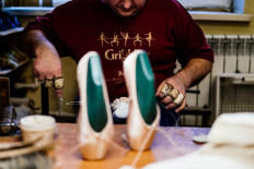 An employee of Grishko company produces pointe shoes in the company's Moscow workshop on February 25, 2020. 