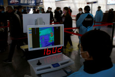 Passengers wearing masks are seen on a thermal screen at the Shanghai railway station in Shanghai, China, as the country is hit by an outbreak of a new coronavirus, February 27, 2020. 