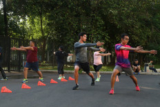 Participants of Fairmont Fit Retreat practice dynamic stretching and ABC running drill at Gelora Bung Karno (GBK) Stadium in Senayan, Central Jakarta. 
