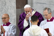 Pope Francis wipes his nose during the Ash Wednesday mass which opens Lent, the forty-day period of abstinence and deprivation for Christians before Holy Week and Easter, on Feb. 26, 2020, at the Santa Sabina church in Rome. Pope Francis, who canceled a Lent retreat for the first time in his papacy because he is suffering from a cold, has tested negative for coronavirus.