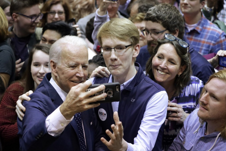 NORFOLK, VIRGINIA - MARCH 01: Democratic presidential candidate former Vice President Joe Biden poses for selfies with supporters during a campaign event at Booker T. Washington High School March 1, 2020 in Norfolk, Virginia. After his major win in South Carolina, Biden continues to campaign for the upcoming Super Tuesday Democratic presidential primaries.   