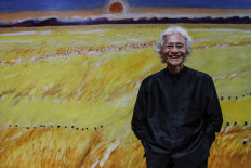 Still going strong: Maestro painter Srihadi Soedarsono poses in front on one of his paintings at his studio in Bandung, West Java, on Jan. 29.