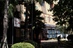 A hospital staff member walks past the isolation unit at the Sulianti Saroso Infectious Diseases Hospital (RSPI Sulianti Suroso) in Jakarta on Monday.