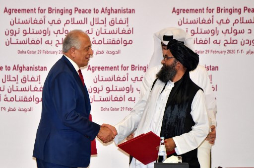 (L to R) US Special Representative for Afghanistan Reconciliation Zalmay Khalilzad and Taliban co-founder Mullah Abdul Ghani Baradar shake hands after signing a peace agreement during a ceremony in the Qatari capital Doha on Feb. 29, 2020. On Monday, a deadly blast shattered a period of relative calm in Afghanistan the Taliban ordered fighters to resume operations against Afghan forces just two days after signing a deal to usher in peace.
