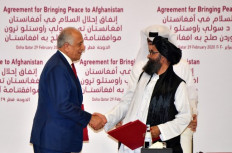 (L to R) US Special Representative for Afghanistan Reconciliation Zalmay Khalilzad and Taliban co-founder Mullah Abdul Ghani Baradar shake hands after signing a peace agreement during a ceremony in the Qatari capital Doha on Feb. 29, 2020. On Monday, a deadly blast shattered a period of relative calm in Afghanistan the Taliban ordered fighters to resume operations against Afghan forces just two days after signing a deal to usher in peace.