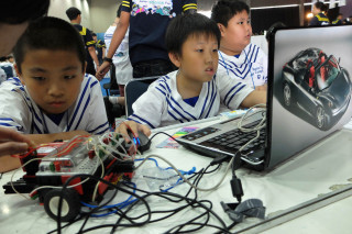 Students try to assemble robots while participating in robotic competitions at a junior science fair, in Ancol Eco Park, Jakarta, in this 2013 photo. 