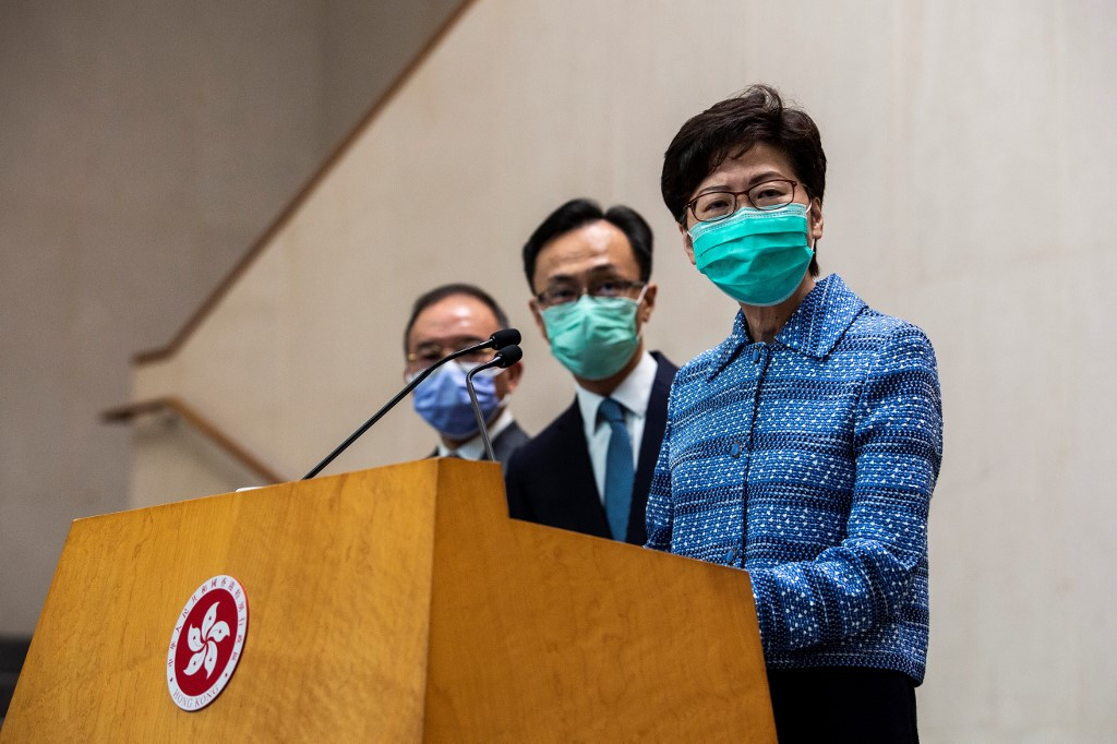 Hong Kong's Chief Executive Carrie Lam (R) takes part in a press conference while wearing a face mask in Hong Kong on March 3, 2020. 