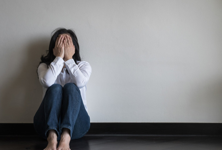 Illustration of a woman struggling with mental health problems