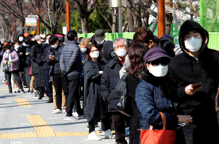 People stand in a long queue to buy face masks at a post office, after a shortage of masks amid the rise in confirmed cases of the novel coronavirus disease COVID-19, in Daegu, South Korea, March 4, 2020. 