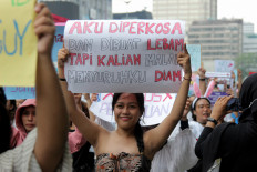 Women take part in an International Women's Day march in Central Jakarta on Sunday.