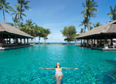 Float back and relax: A woman is seen swimming in a large pool facing the ocean beachside, at the Intercontinental Bali Resort in Bali, in this undated picture.