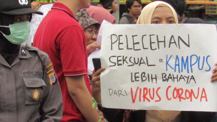 People march to mark the 2020 International Women's Day in Yogyakarta on March 8. The march raised awareness about the fight against sexual violence at universities in the city. The pictured sign reads: 