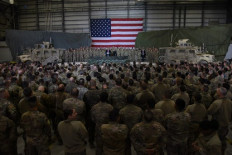 Afghan's President Ashraf Ghani and US President Donald Trump speak to US soldiers during a surprise Thanksgiving day visit at Bagram Air Field, on Nov. 28, 2019 in Afghanistan. Troops have started leaving one base in Lashkar Gah, the capital of Helmand province in the south, and another base in Herat in the east.