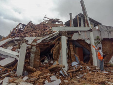 Villagers inspect their collapsed homes in Sukabumi, West Java, after a 4.9 magnitude earthquake hit the area on March 10.