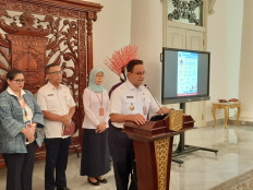 Jakarta Governor Anies Baswedan speaks at a press conference at City Hall on March 11, 2020.