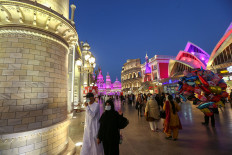 People wear protective masks, following an outbreak of coronavirus, as they walk at Global Village in Dubai, United Arab Emirates, March 10, 2020.The United Arab Emirates said citizens and residents will be allowed to travel to countries deemed low-risk for catching the coronavirus from next Tuesday.