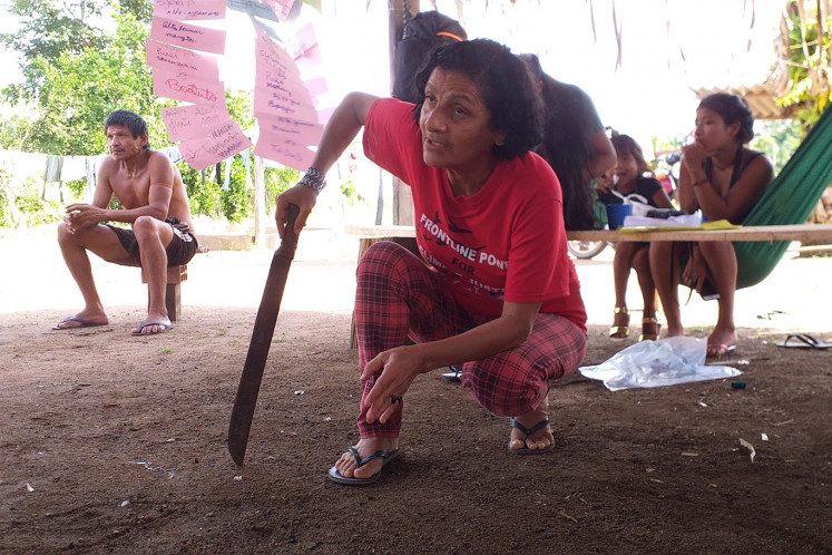 Ivaneide Bandeira holds a machete during a meeting held at Aldeia Nova, a Uru-Eu-Wau-Wau village deep in the Amazon, Brazil, February 18, 2020.