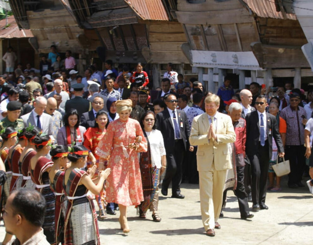 Dutch King Willem-Alexander (right) and Queen Maxima (left) are welcomed by a Batak traditional 'tor-tor' dance on March, 12, 2020, during their visit to Lintong Ni Huta village in Toba regency, North Sumatra.