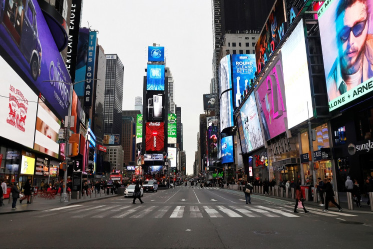 A nearly empty 7th Avenue in Times Square is seen at rush hour after it was announced that Broadway shows will cancel performances due to the coronavirus outbreak in New York, United States, on March 12, 2020. 