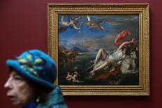 A visitor walks past the Titian's 'The Rape of Europa' painting at a media preview of Titian: Love Desire Death exhibition at the National Gallery in London, Britain, on March 12, 2020. 