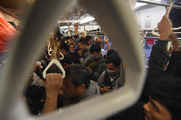 Commuters on a train from Jakarta to Bogor on March 12. (Antara/Indrianto Eko Suwarso)