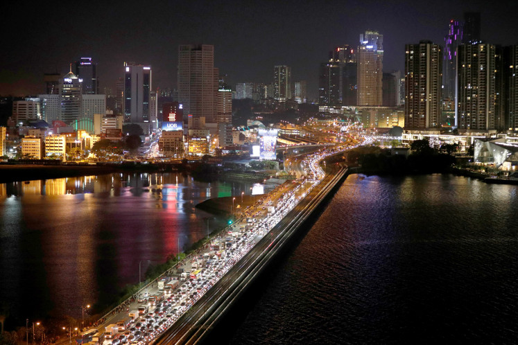 Vehicles line up to enter Singapore from Johor on the Woodlands Causeway, hours before Malaysia imposes a lockdown on travel due to the coronavirus outbreak March 17, 2020.  
