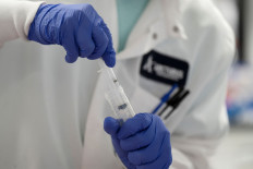 A scientist conducts research on a vaccine for the novel coronavirus (COVID-19) at the laboratories of RNA medicines company Arcturus Therapeutics in San Diego, California, U.S., March 17, 2020. 