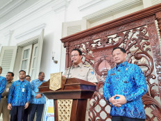 Jakarta Governor Anies Baswedan (center) and Home Minister Tito Karnavian (right) at a press conference on COVID-19 at Jakarta's City Hall on March 17.