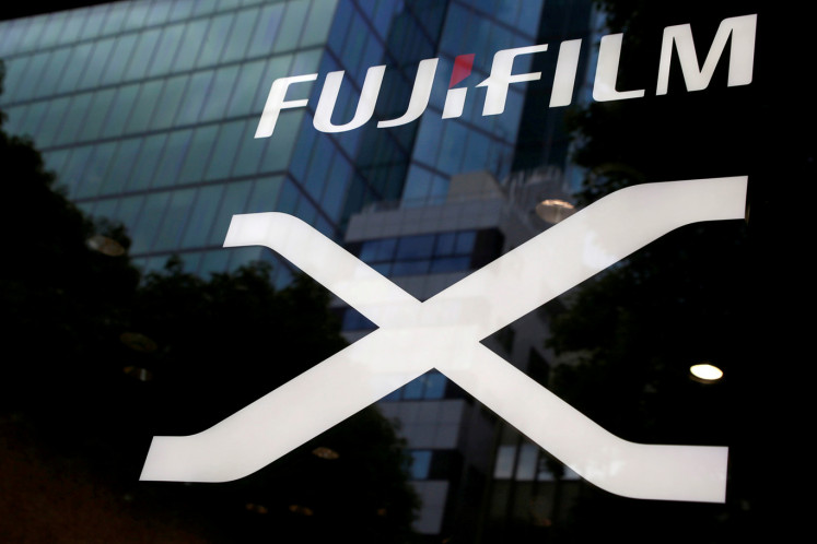 Fujifilm's company logo (top) is seen at its exhibition hall nearby the headquarters of Fujifilm Holdings Corp in Tokyo, Japan June 12, 2017.  