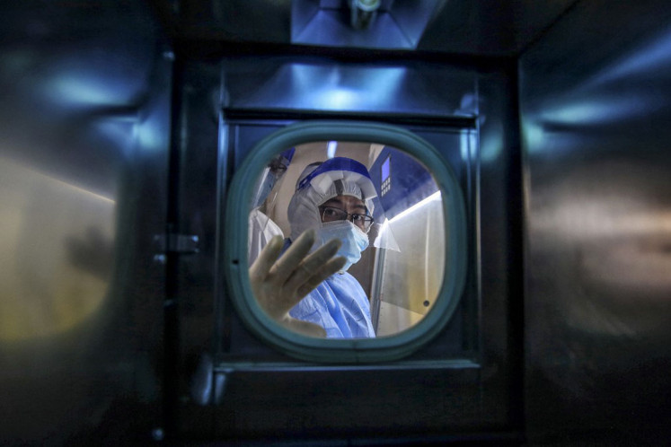 A medical staff member gestures inside an isolation ward at Red Cross Hospital in Wuhan in China's central Hubei province on March 10, 2020. 