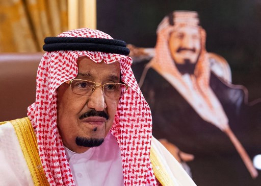 A handout picture provided by the Saudi Royal Palace on Thursday in the capital Riyadh shows Saudi King Salman bin Abdulaziz speaking during a televised speech, addressing the nation about the COVID-19 coronavirus disease pandemic.