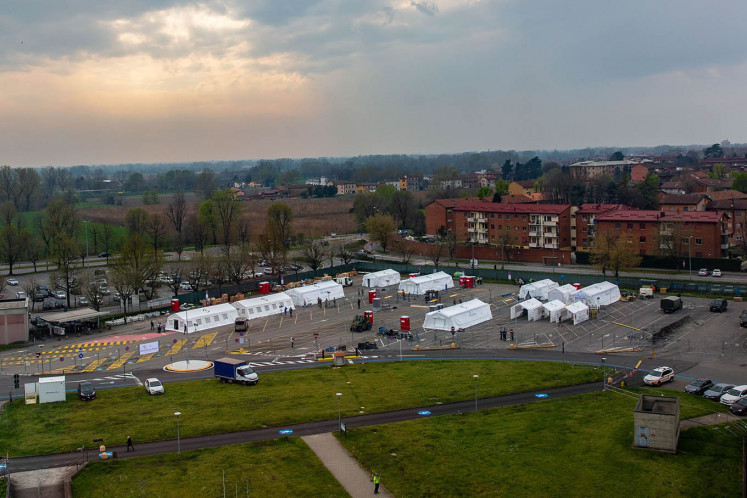 Tents being constructed to form a field hospital, run by non-governmental organisation Samaritans Purse, stand in a parking lot in Cremona, Italy, on Friday, March 20, 2020. Prime Minister Giuseppe Conte's government is set to reinforce and extend the near-total lockdown on Italy as it struggles to contain the coronavirus, after overtaking China as the country with the highest recorded number of deaths. 