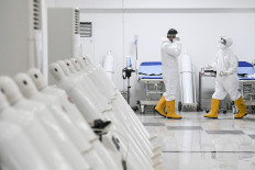 Medical workers check equipment that is used to treat coronavirus patients at the Kemayoran athletes village makeshift hospital for COVID-19 cases in Central Jakarta on March 23, 2020.