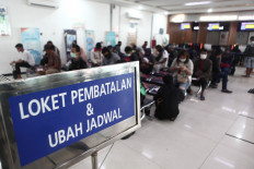 Passengers line up to reschedule their train tickets at Senen Station in Jakarta on Thursday.