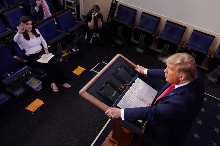CNN White House correspondent Kaitlan Collins attempts to ask a question as U.S. President Donald Trump leads the daily coronavirus response briefing at the White House in Washington, U.S. March 26, 2020.  
