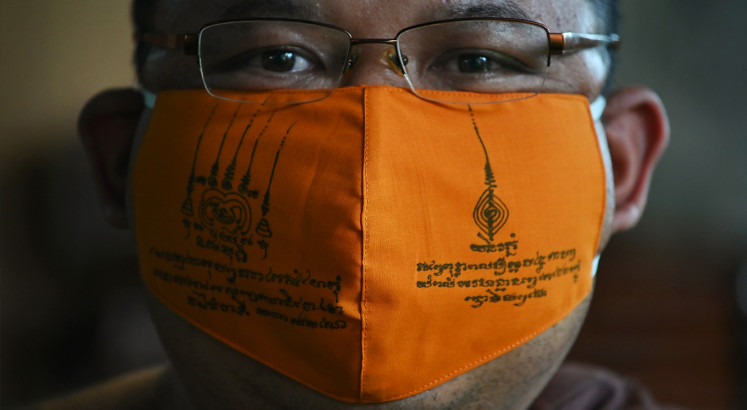Thai monks make virus masks from recycled plastic
